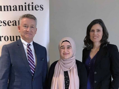 “Why Humanities?” competition winner Rima Asfour (centre) accepts congratulations from UWindsor interim president Douglas Kneale and Humanities Research Group director Kim Nelson.
