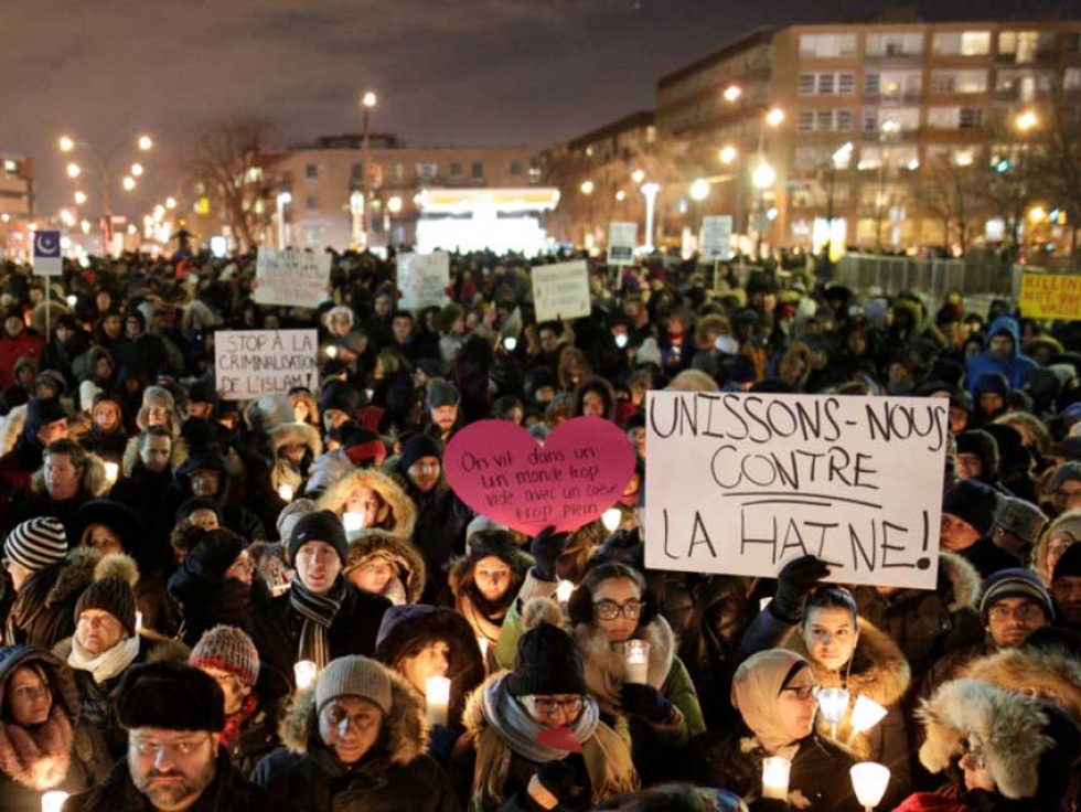 Here people attend a Montréal vigil for the Québec City victims on January 30, 2017