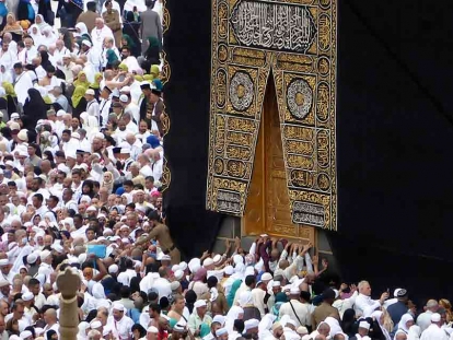 Umrah pilgrims pray near the Kaaba in Mecca, Saudi Arabia