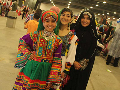 Girls wear traditional Afghan clothing at the MAC Eid and Summer Festival&#039;s Country Exhibition.